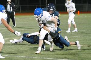 The Bainbridge defense tries to wrap up Olympic running back Trent Feistner. (Mark Krulish/Kitsap News Group)