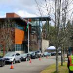 <em>Cars line the parking lot of Olympic College in Poulsbo as eligible folks wait to get their COVID-19 vaccine.</em>		 Ken Park/North Kitsap Herald