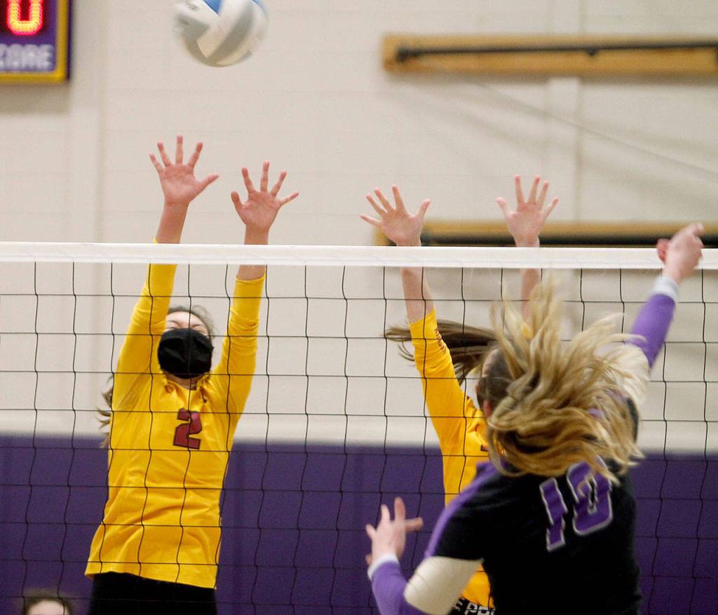 Kingstons Nizhoni Price tries to get in the way of Riley Rabedeauxs spike. (Mark Krulish/Kitsap News Group)