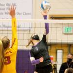 Lillian Pruden puts a shot past the Kingston blockers during North Kitsaps final volleyball match of the season. (Mark Krulish/Kitsap News Group)