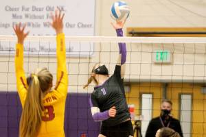 Lillian Pruden puts a shot past the Kingston blockers during North Kitsaps final volleyball match of the season. (Mark Krulish/Kitsap News Group)