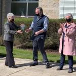 Steve Sego, owner of The Dock Bar Eatery, stands alongside co-owner Coreen Haydock as he accepts a certificate of appreciation from Alfie Alvarado, director of the Washington state Department of Veterans Affairs. (Bob Smith | Kitsap Daily News)