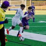 Bainbridge forward Damoni Mckenna-Greenawalt looks to break away down the sideline as North Kitsaps Dylan Brindle gives chase. (Mark Krulish/Kitsap News Group)