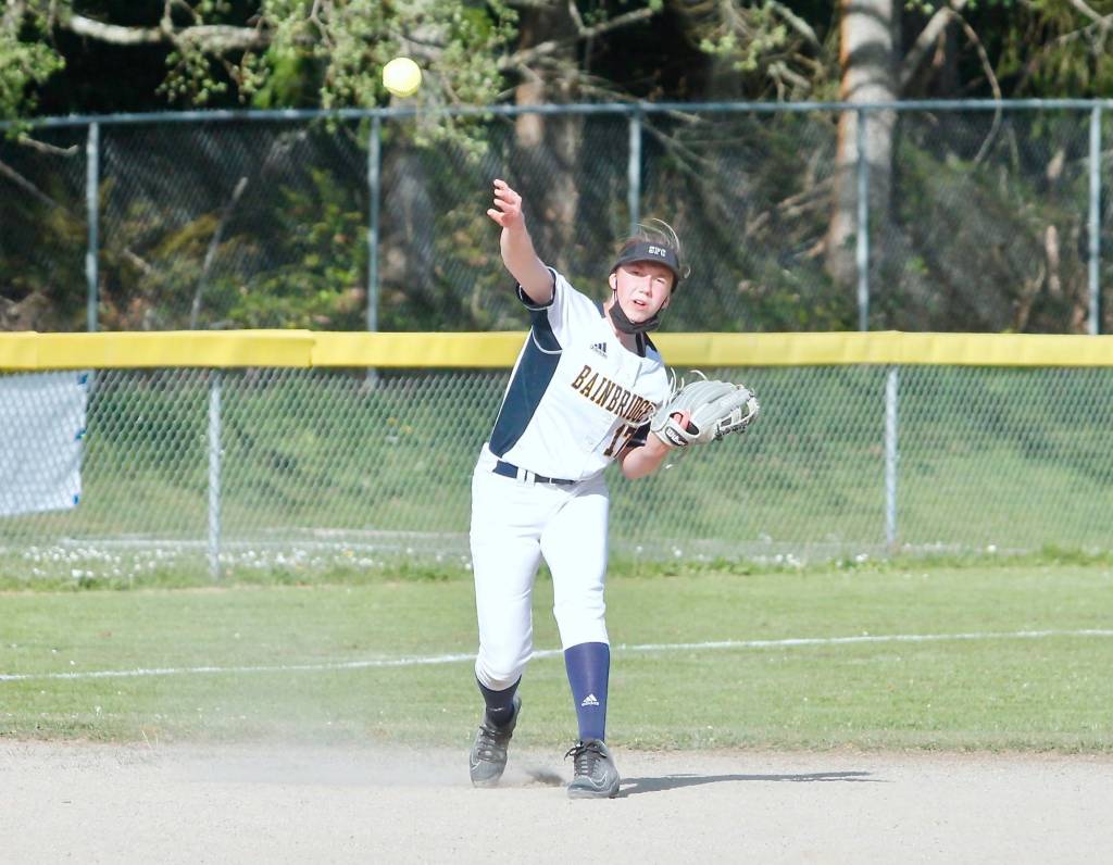 Grace Colburn makes the long throw from the shortstop position. (Mark Krulish/Kitsap News Group)