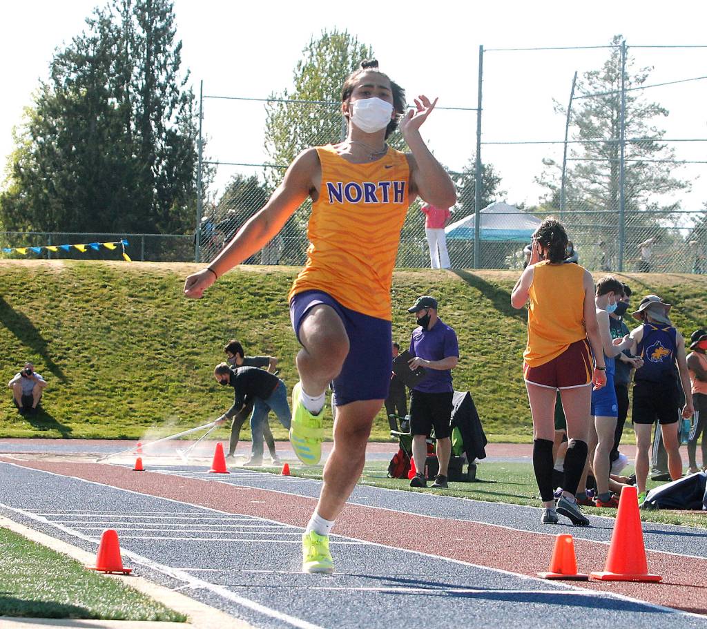 Lincoln Castillo makes his leap in the long jump. He finished third with a jump of 19 feet, 10.5 inches. (Mark Krulish/Kitsap News Group)