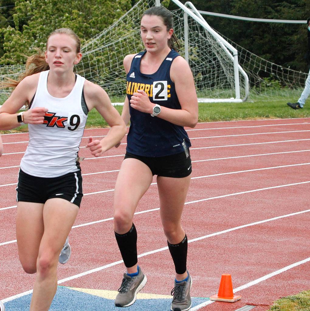 Bainbridges Lucy King chases down a pack in the 3200-meter run. (Mark Krulish/Kitsap News Group)