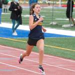 Claire Maclise crosses the finish line in the second heat of the 200-meter dash. (Mark Krulish/Kitsap News Group)