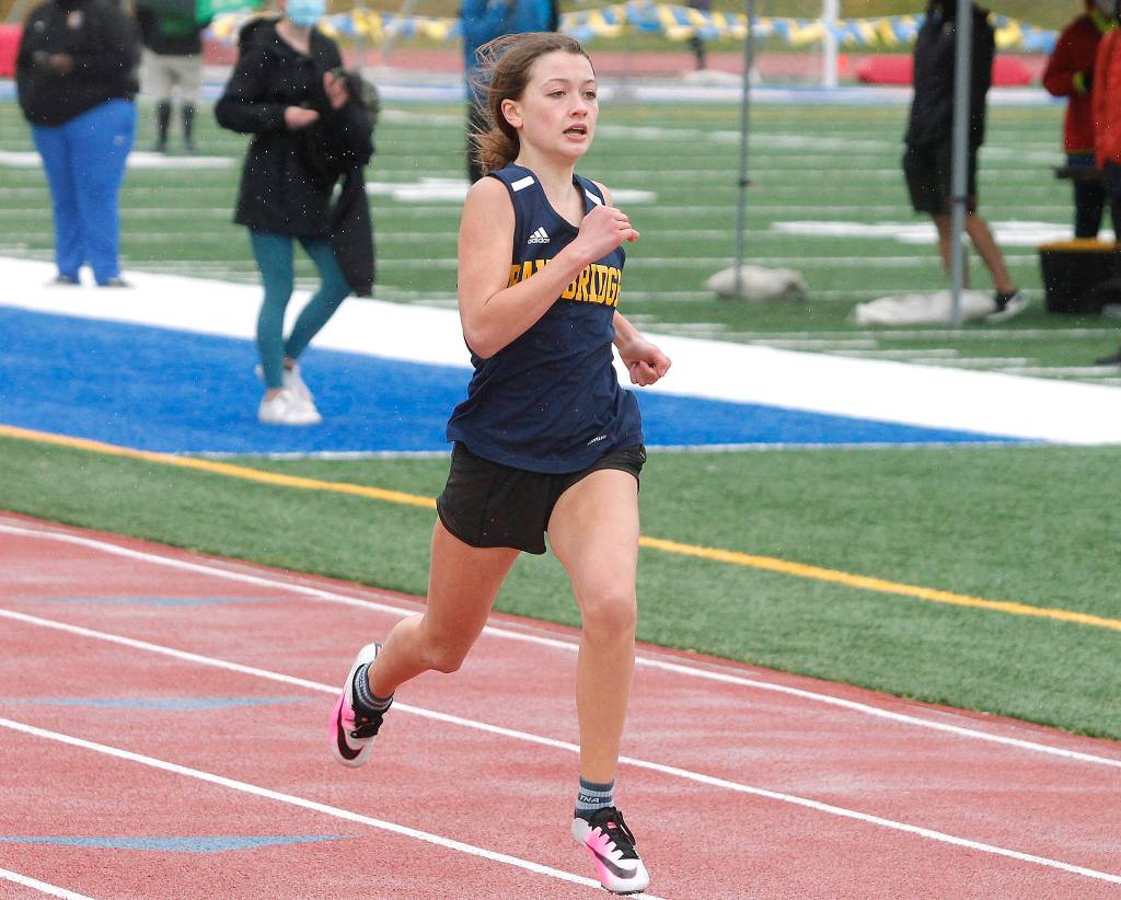 Claire Maclise crosses the finish line in the second heat of the 200-meter dash. (Mark Krulish/Kitsap News Group)