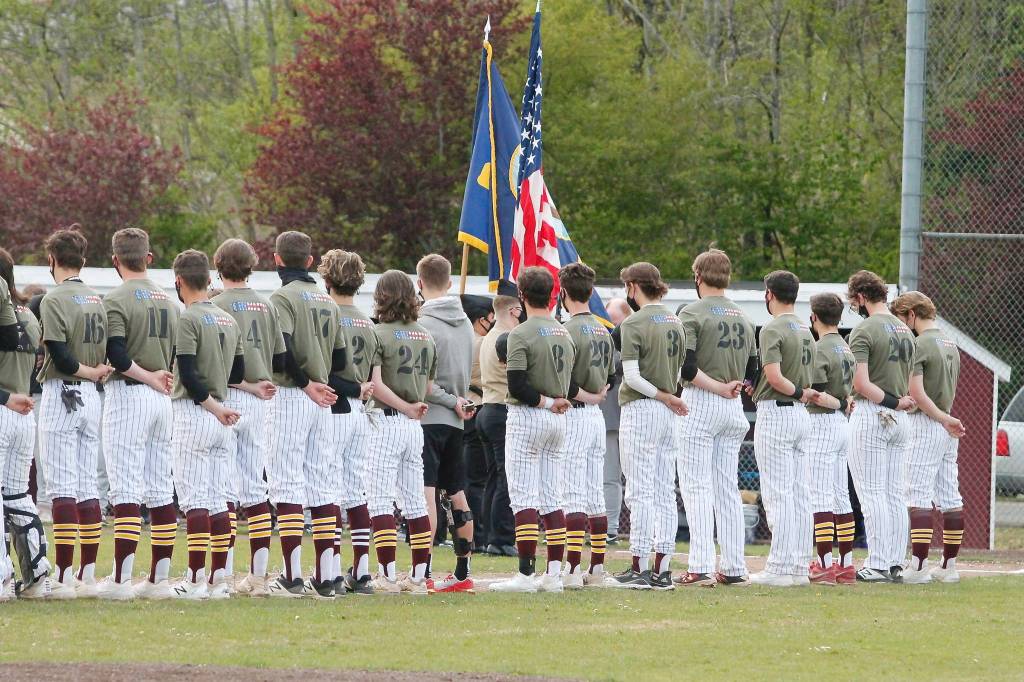 The team sports their specially-made jerseys for their Tribute to the Troops game during a pregame ceremony. (Mark Krulish/Kitsap News Group)