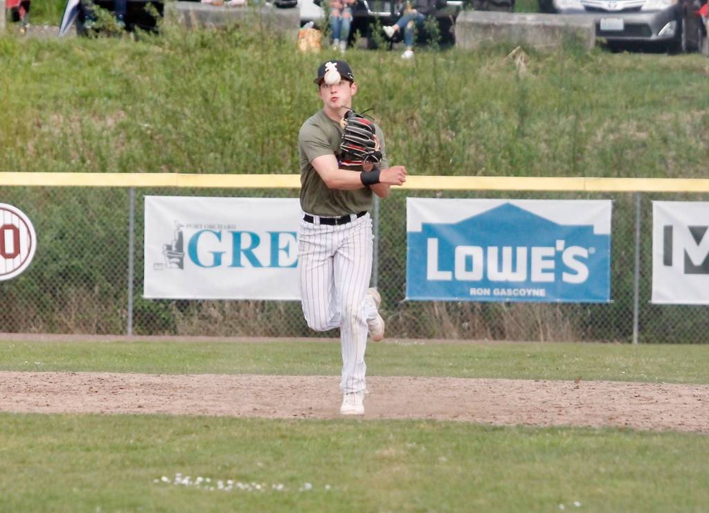 Rylen Bayne makes the throw from first after picking up a grounder at shortstop. (Mark Krulish/Kitsap News Group)