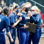 The Spartans gather around as they receive the plaque commemorating their league championship. (Mark Krulish/Kitsap News Group)