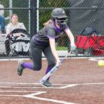 Samantha Burgh drops down a bunt against Sequim. Burgh recorded two hits and a sacrifice in the 2-1 victory. (Mark Krulish/Kitsap News Group)