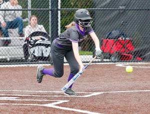 Samantha Burgh drops down a bunt against Sequim. Burgh recorded two hits and a sacrifice in the 2-1 victory. (Mark Krulish/Kitsap News Group)
