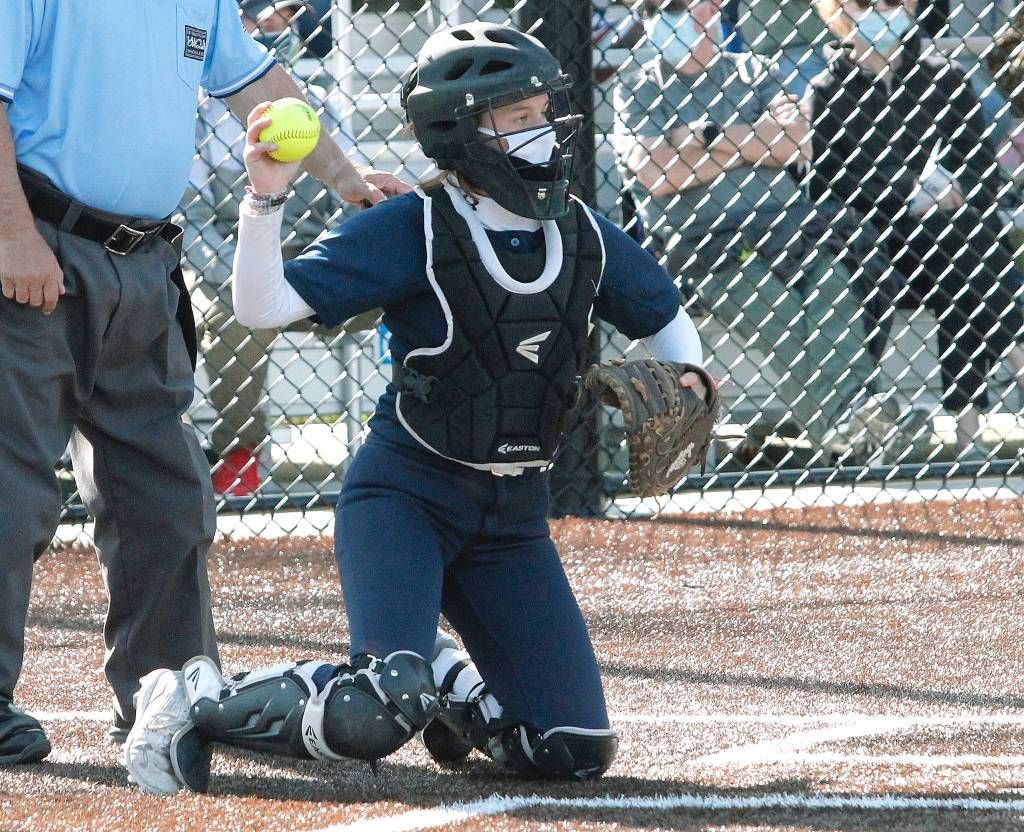 Bainbridge catcher Ruby Raymundo makes the throw from behind the plate. (Mark Krulish/Kitsap News Group)