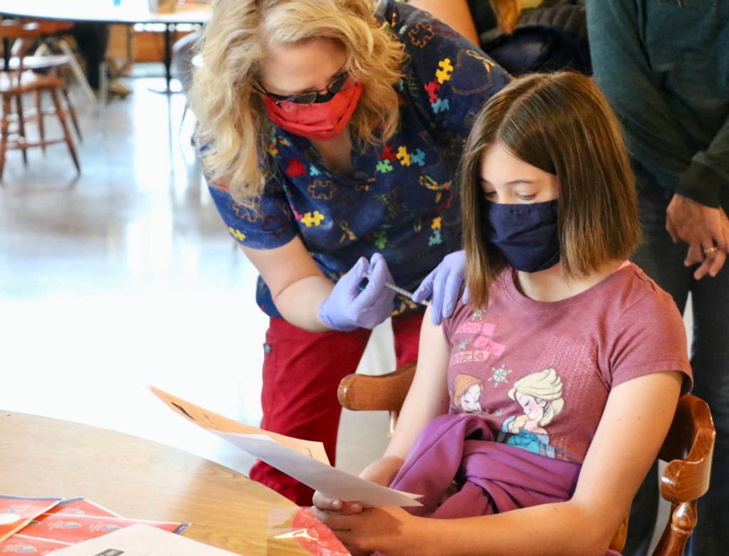 Eliora McDaniel, daughter of Dr. Luke McDaniel, is unphased as she gets her first  dose of the Pfizer vaccine.(KPark/NKH).