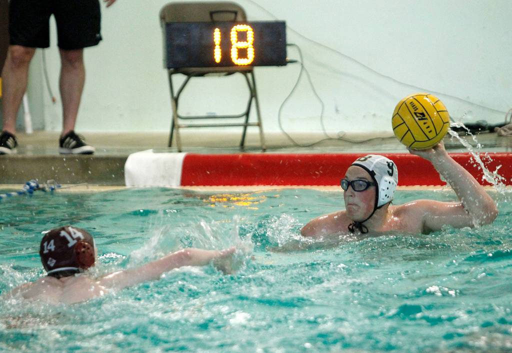 Logan OHare looks to get a shot past South Kitsaps Hank Spangler (14). (Mark Krulish/Kitsap News Group)