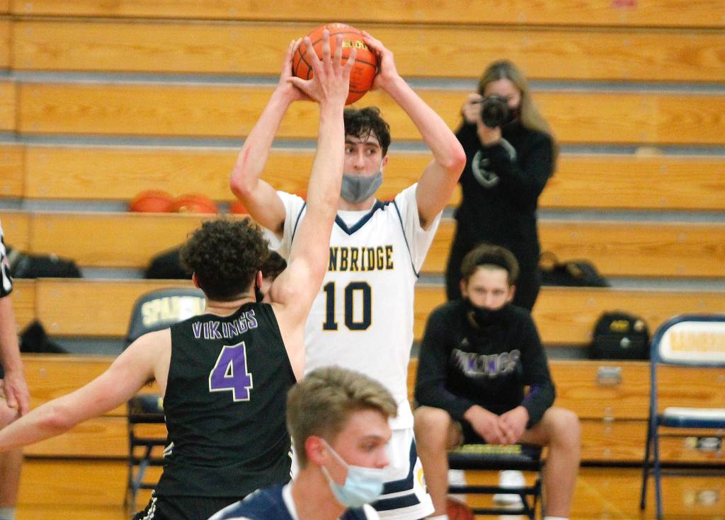 Alexander Treskin looks for an open teammate while Jonas La Tour (4) gets his hands up to block the passing lanes. (Mark Krulish/Kitsap News Group)