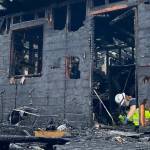Deputy fire marshal Kristi Wlodarchak photographs the area of origin of the fire that displaced five and severely damaged a home.