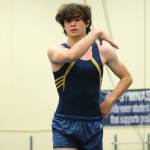 Aidan Cretarolo stands tall on the balance beam. (Mark Krulish/Kitsap News Group)