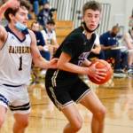 North Kitsaps Cade Orness looks to dribble past Bainbridge guard Jacob Kirsch. Orness tied Mondays semifinal match with a 3-pointer at the buzzer in regulation. The Vikings won in overtime. (Mark Krulish/Kitsap News Group)