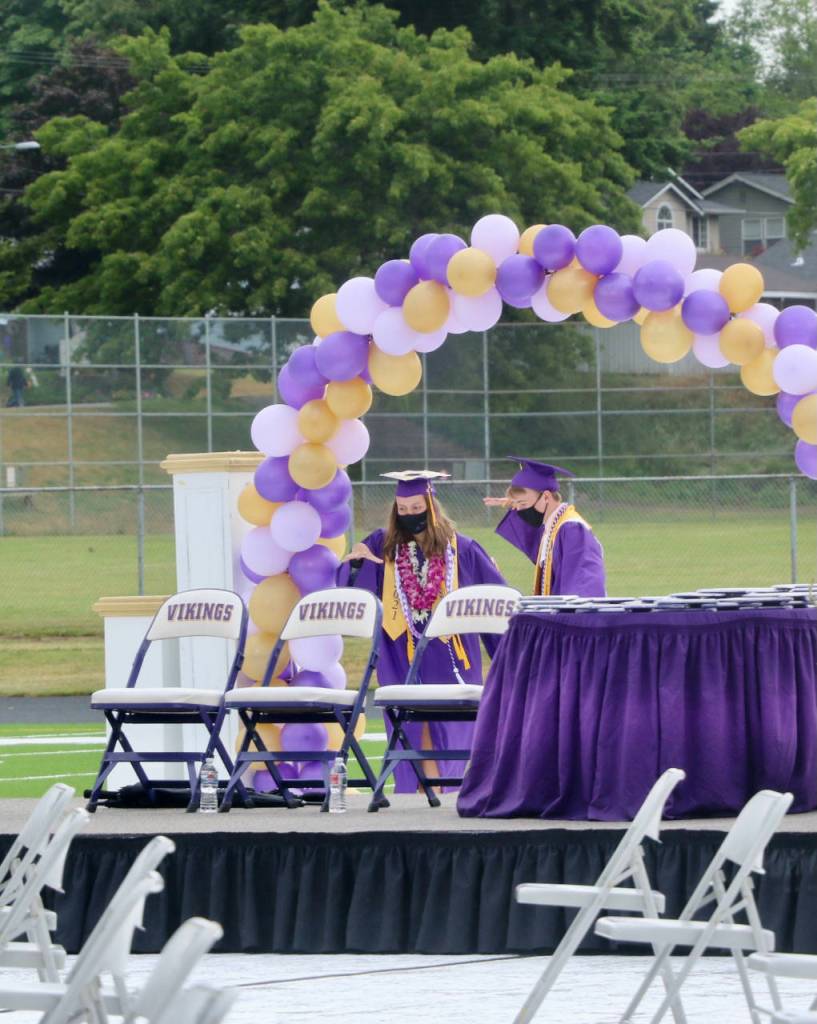 Brianna Hoffman and Christopher Carthum glide through the purple and gold arch. (KPark/NKH).