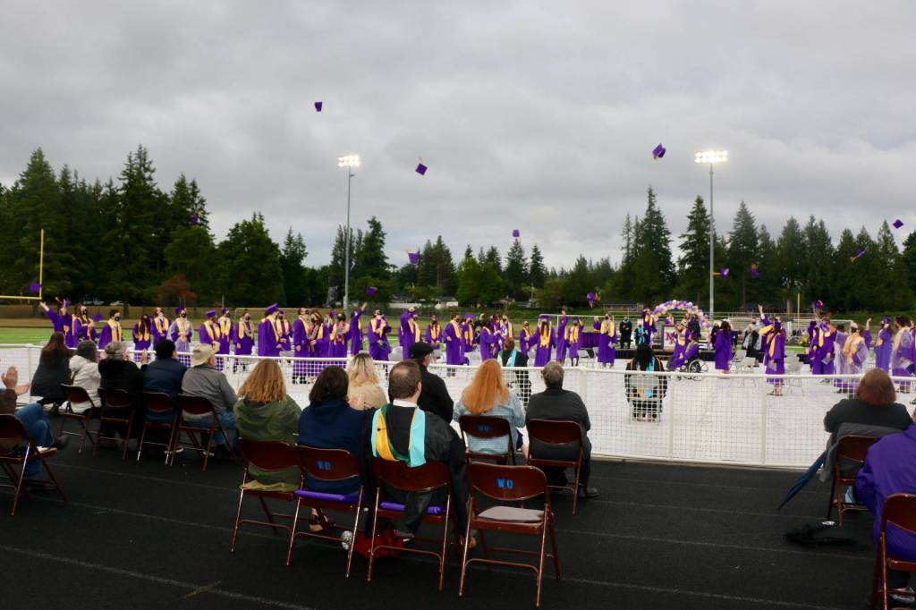 Caps hit the wet air as the Class of 2021 officially graduates. (KPark/NKH).