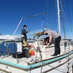 Members of the Port Orchard Sea Scouts work onboard the Flamingo 3 sailboat. (photo courtesy of Bob Hancock)