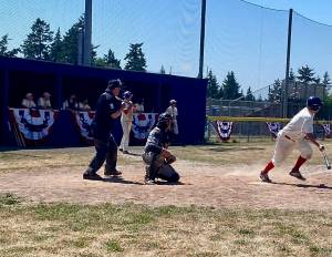 Ben Kussie digs out of the box for the Reds in the 18th annual old-timers and alumni Stars and Strikes game as MacKenzie Bond waits on deck. Bond tripled home Kussie in the bottom of the seventh to tie the game and send it to extra innings. (Photo courtesy Paimon Jaberi)