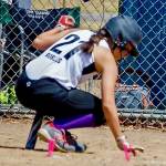 Cadence Robles reaches down into the dirt to honor the memory of classmate Gee Still, who recently passed away in an accident. Kris Bartlett Courtesy Photos