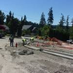 Crews work to form the curbing of the roundabout.