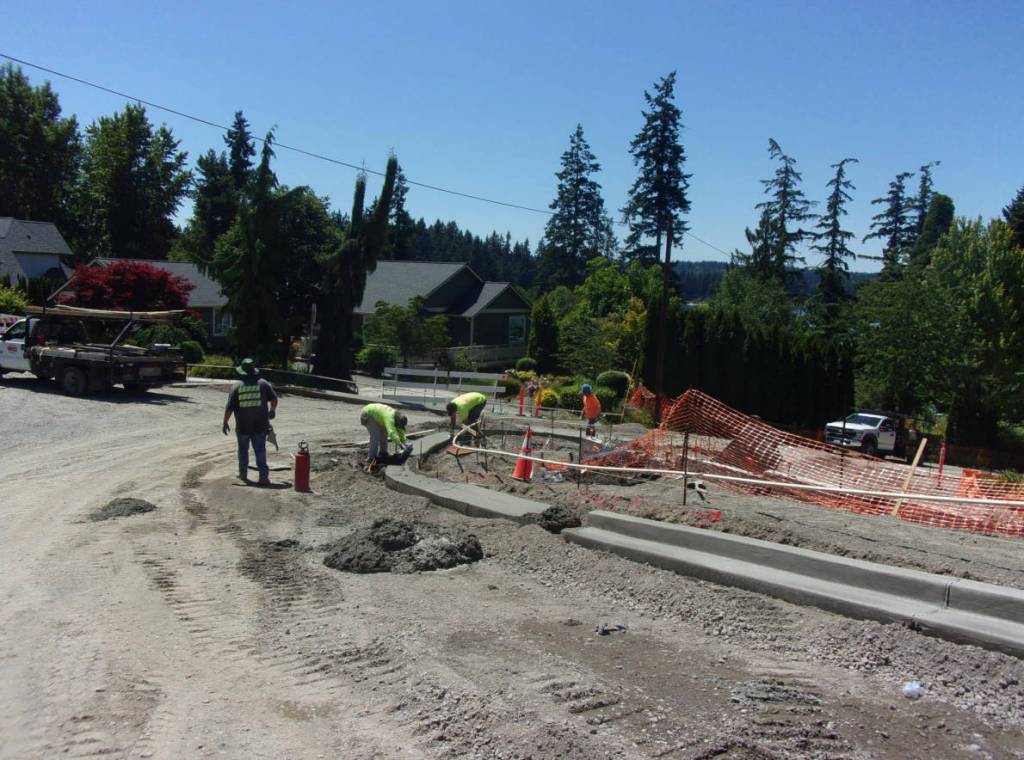 Crews work to form the curbing of the roundabout.