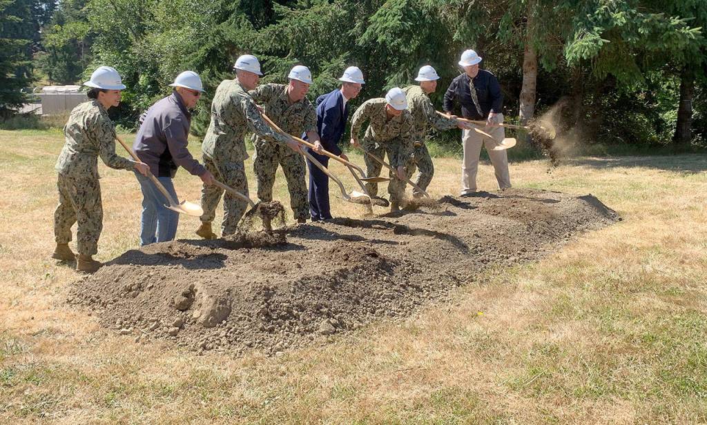 Navy officials and U.S. Rep. Derek Kilmer turn over shovels of dirt to signify the official start of the project to modernize the Manchester Fuel Depots fuel storage capability. (Bob Smith | Kitsap Daily News)