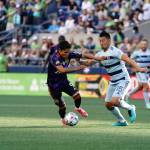 Raul Ruidiaz tries to squeeze by a Sporting KC defender in Seattles 3-1 loss on Sunday at Lummen Field. (Mike Fiechtner/Sounders FC Communications)