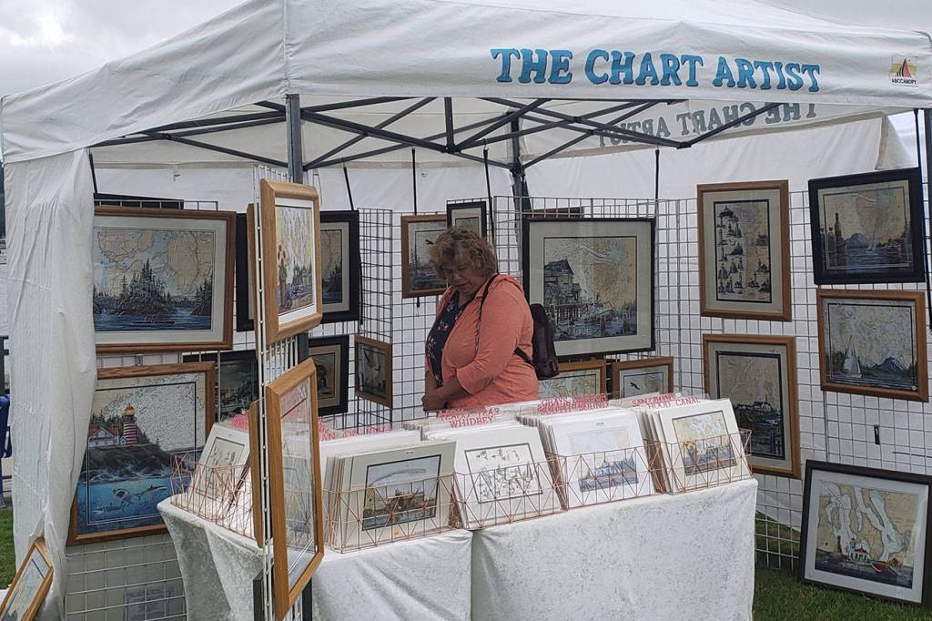 A visitor peruses through various maps and photos of Western Washington areas.