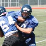 Bainbridge senior Connor Sweeny wraps up a teammate during practice. (Mark Krulish/Kitsap News Group)