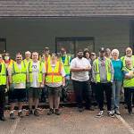 At least 35 volunteers joined forces earlier this month to clean up property surrounding a building on Mile Hill Road in South Kitsap that was purchased by Kitsap County last spring to provide a temporary emergency housing shelter. (Courtesy photo)