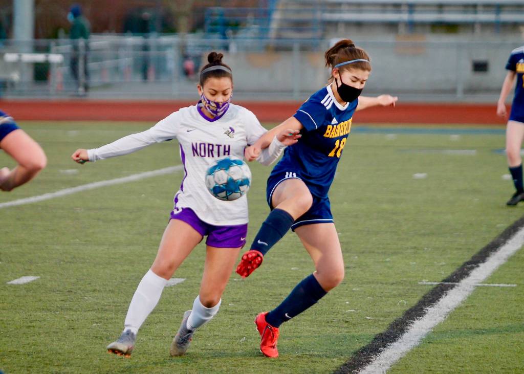 The girls soccer returns all but three players from last years successful team, including Hailey Fink, showing here battling for a loose ball against North Kitsap. (Review file photo)