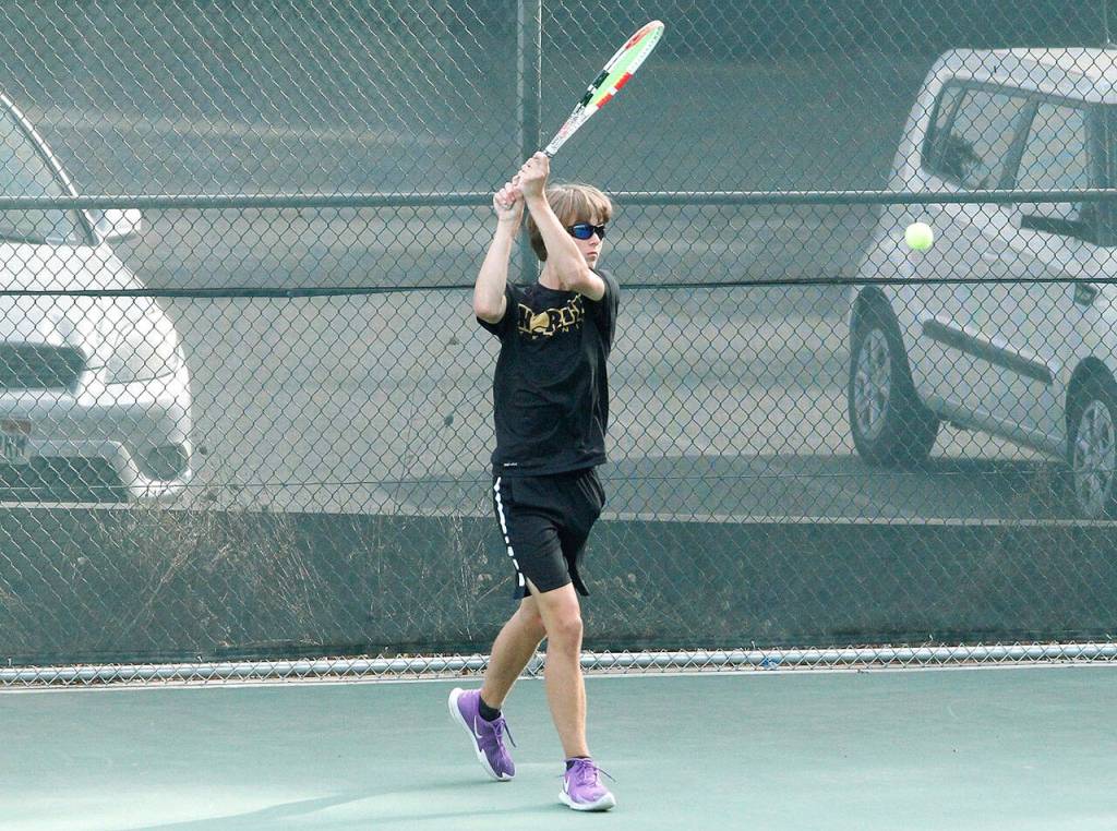 NK freshman Indigo Gallagher Zapf returns serve in his singles match against Bainbridge. (Mark Krulish/Kitsap News Group)