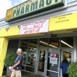 South Park Pharmacy customers hurriedly enter and exit the store before it closed last week. (Bob Smith | Kitsap Daily News)