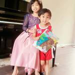 Ilyannie Tuason-Gonzalez of Port Orchard, shown here with her brother Rohan, is pretty great at just about anything she sets her mind to do, including winning spelling bees and writing a book  at the age of 9. (courtesy photo)