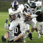 North Kitsaps Zeke Harris, front, gets an assist from teammate Lincoln Hawkins before being wrapped up by the Port Angeles defense on Friday night at Port Angeles Civic Field. (Keith Thorpe/Peninsula Daily News)