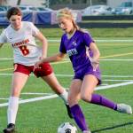Evelyn Beers looks to make a pass back to the middle of the field as shes defended by Kingstons Genevieve Upton. (Mark Krulish/Kitsap News Group)