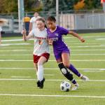 Kamora McMillian tries to step past Kingstons Cora Caldis. McMillian is a team captain and one of just five seniors on North Kitsaps girls soccer team this year. (Mark Krulish/Kitsap News Group)