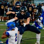 Bainbridges Caleb Durrance closes in on fallen Bremerton quarterback Joshua Tapangco during the Spartans 32-0 loss to the Knights. (Mark Krulish/Kitsap News Group)