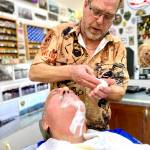 Barber Jeff Crenshaw applies shaving cream on a customers face at his shop, which retained the name Lennys Classic Barbershop after he purchased the business (Gov. Inslee reinstated indoor masking requirements on Aug. 23). (Bob Smith | Kitsap Daily News)
