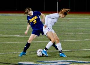 Bainbridge senior Maddy Brown looks to pry the ball loose from a Sequim player during her teams 1-0 win Thursday night. Mark Krulish/Bainbridge Island Review photos