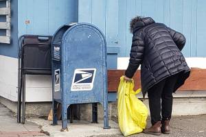 A volunteer helps pick up trash as part of Puget Soundkeepers Poulsbo cleanup. Tyler Shuey/North Kitsap Herald photos
