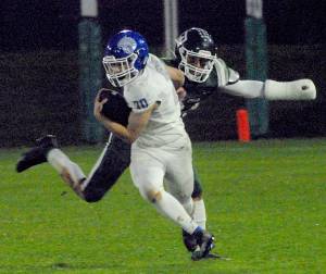 Olympics Joshua Gauyan evades the defense of Port Angeles Jeremiah Hall on Friday night in Port Angeles. (Keith Thorpe/Olympic Peninsula News Group)