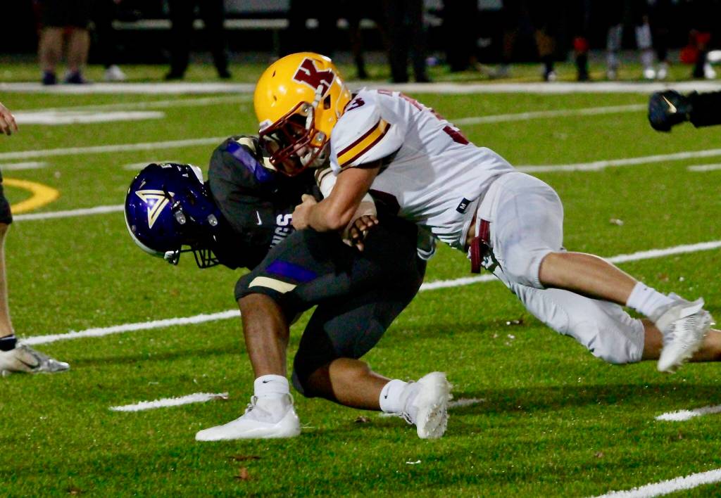 Kingstons Camden Singer shoots through the line to make a tackle in the backfield against North Kitsap. (Mark Krulish/Kitsap News Group)