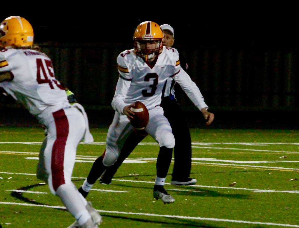 Kingston QB Dakota Standley rolls out looking for a receiver downfield. (Mark Krulish/Kitsap News Group)